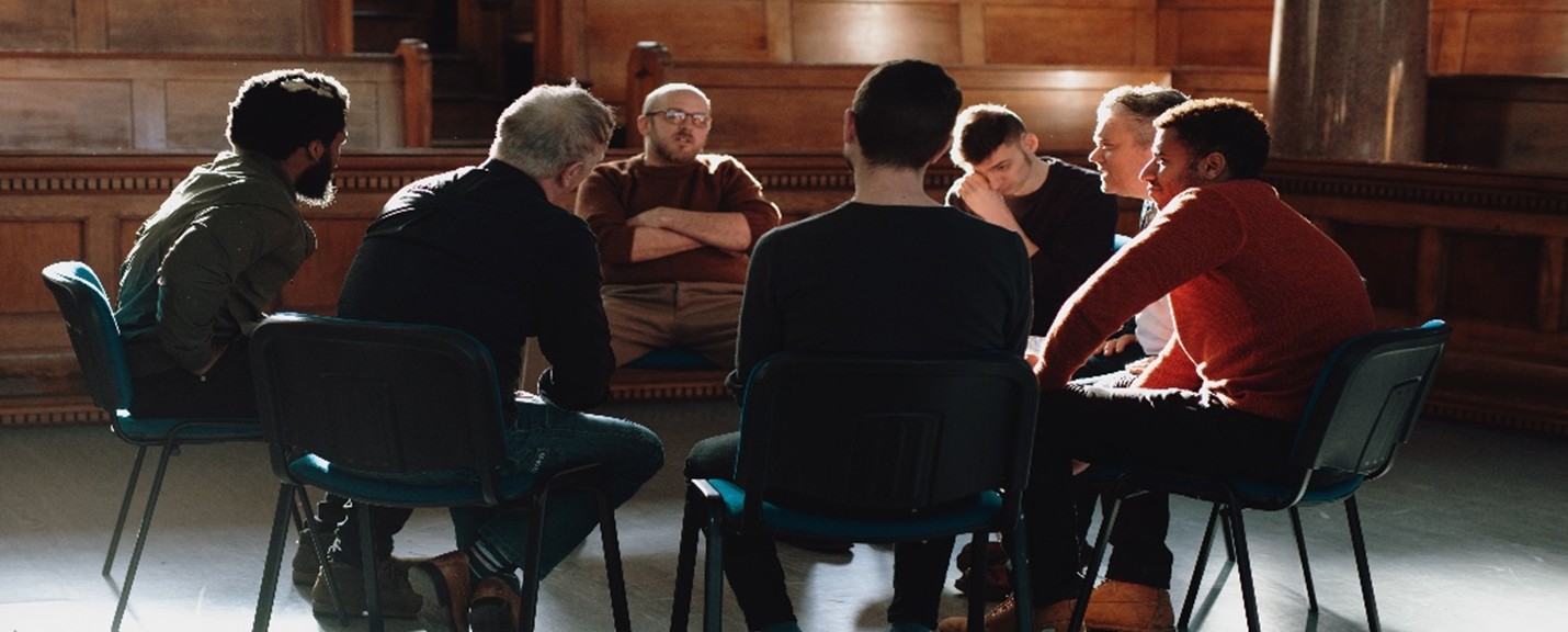group of people sitting in a circle