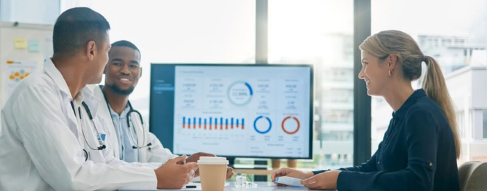 Healthcare professionals reviewing data on a digital healthcare dashboard.